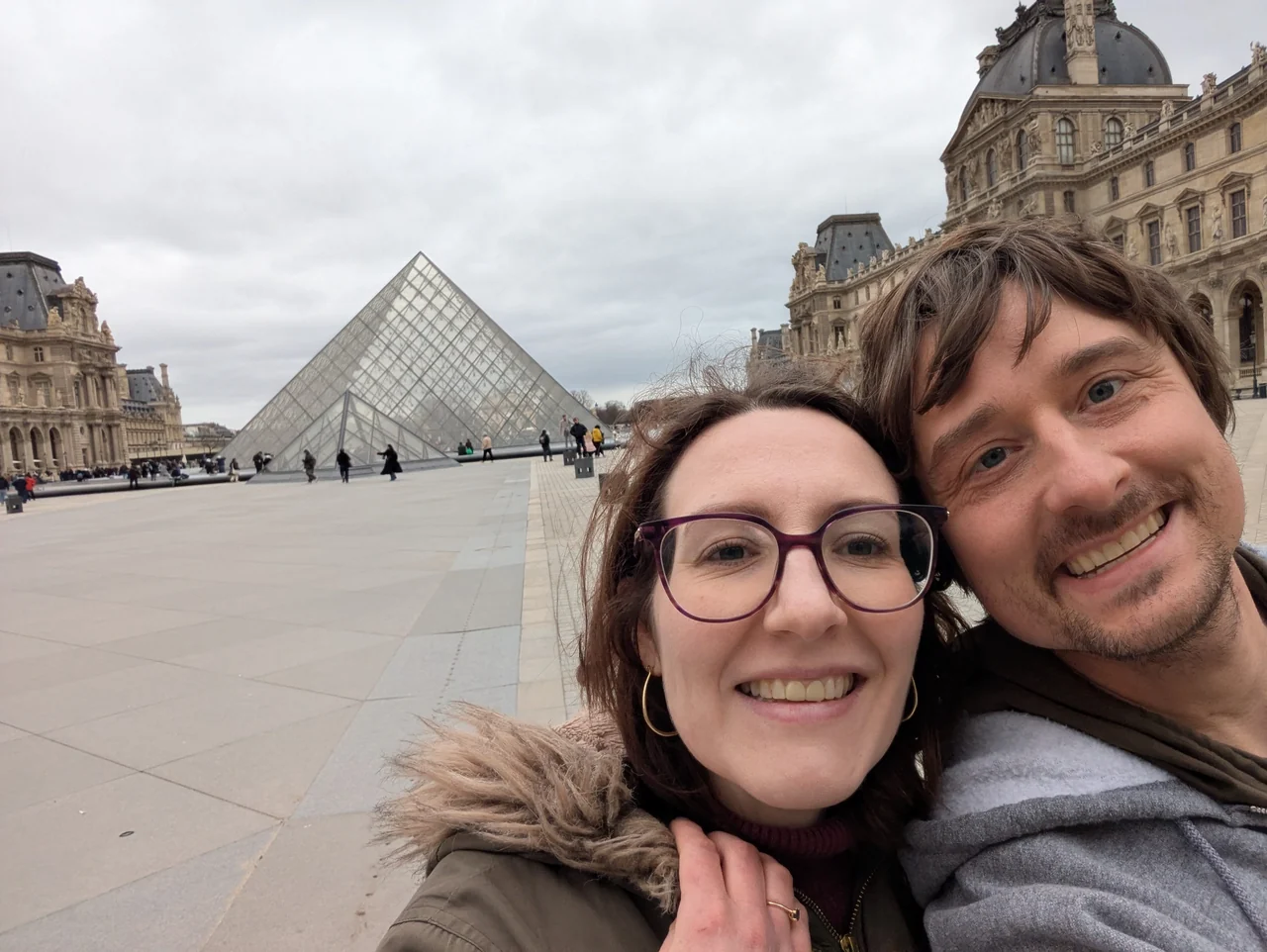 Hannah and Mike smiling outside the Louvre