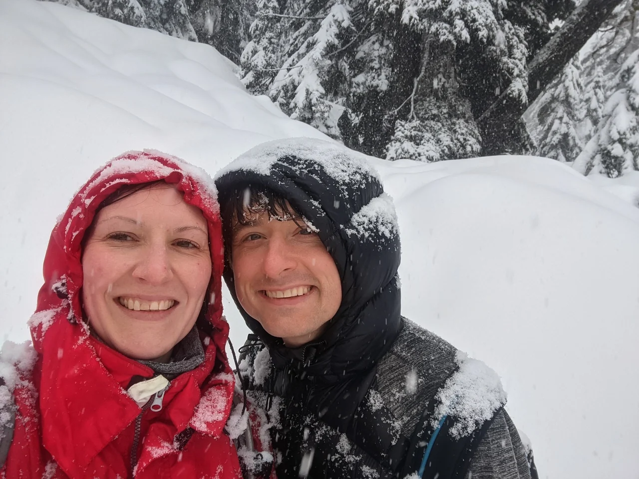 Hannah and Mike smiling together in falling snow